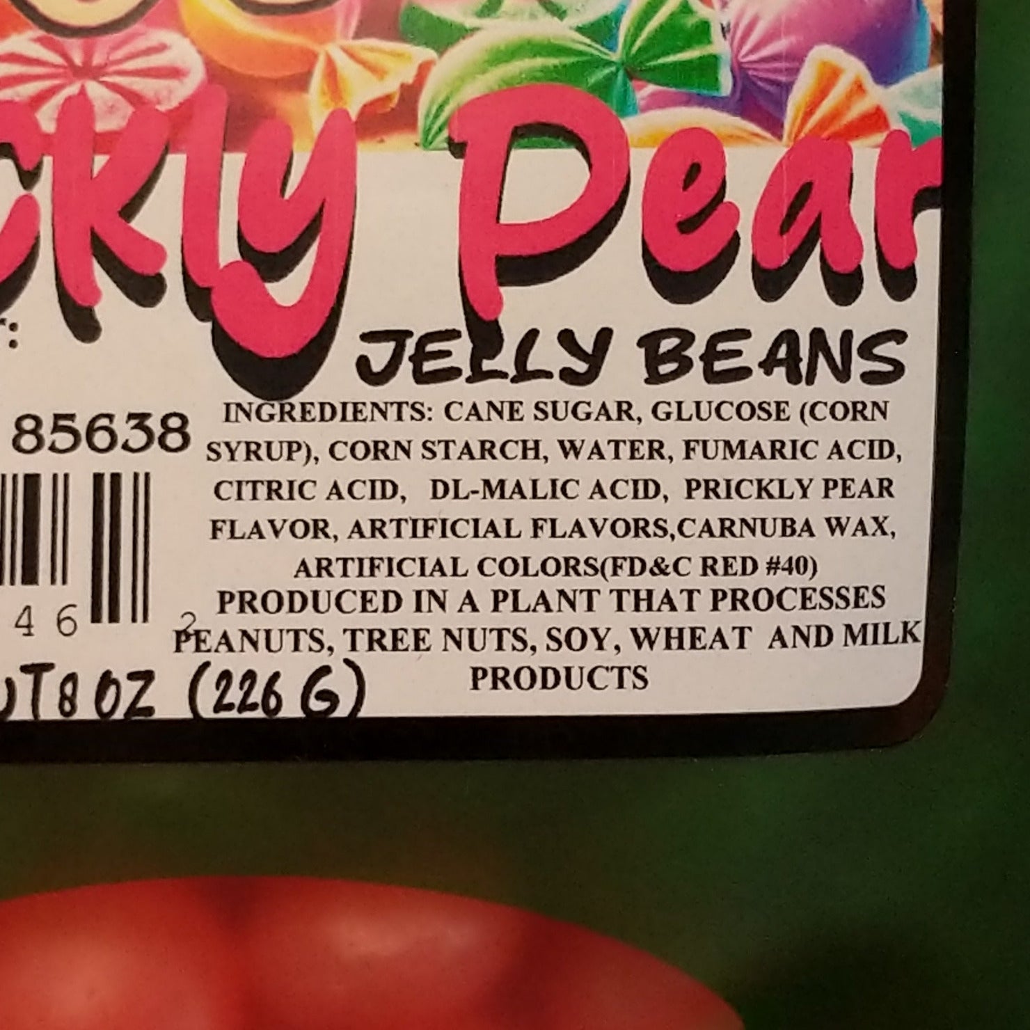 Bright sour prickly pear jelly beans with a sugary coating, displayed in a colorful pile. The candy features vibrant pink and purple tones and combines sweet prickly pear flavor with a tangy sour finish.