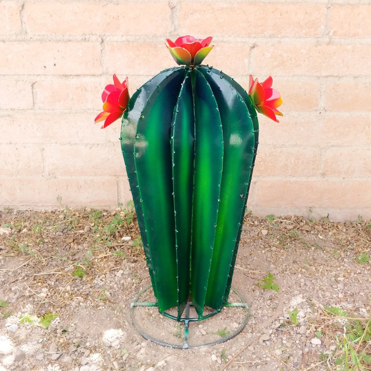 Medium metal saguaro sculpture, featuring orange blooms.