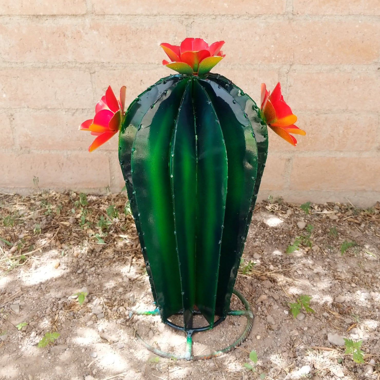 Small metal saguaro sculpture, featuring orange blooms.