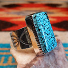 Sterling silver ring with Spiderweb Kingman turquoise set in a rectangular bezel.