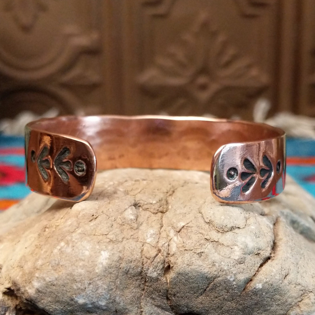 Copper and sterling silver cuff with spine oval stamping on the silver.
