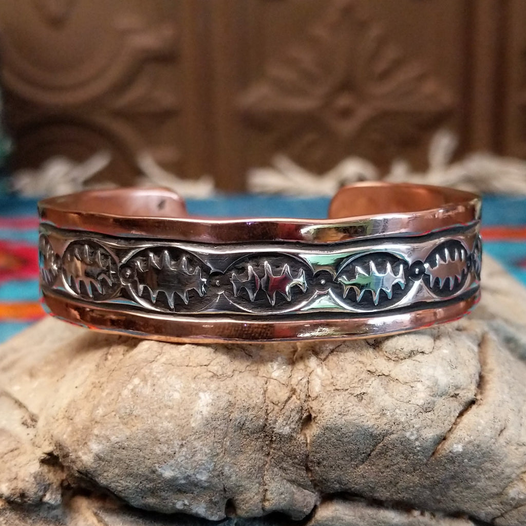 Copper and sterling silver cuff with spine oval stamping on the silver.