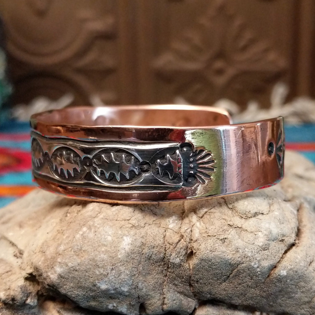 Copper and sterling silver cuff with spine oval stamping on the silver.