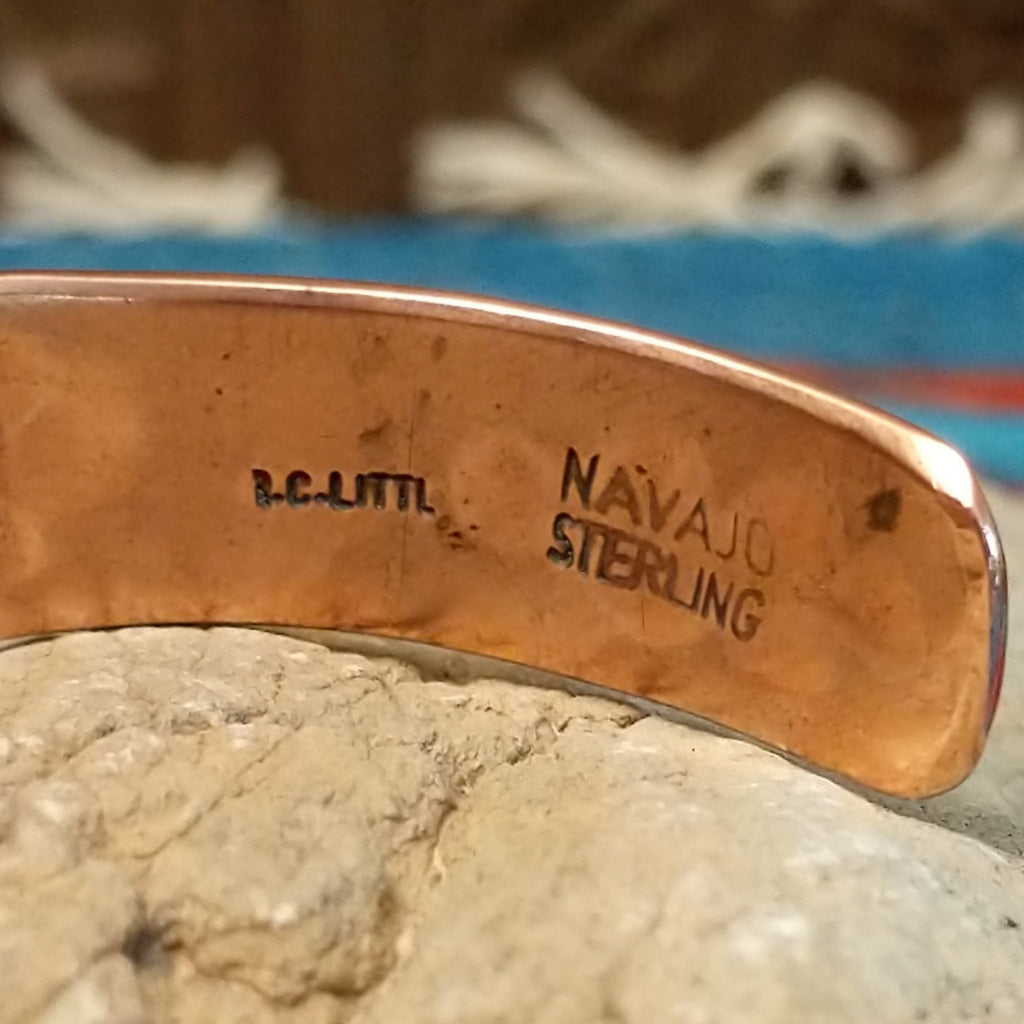 Close-up of the artisan's stamped signature.