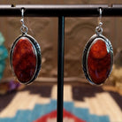 Sterling silver earrings with spiny oyster shell set in oval bezels, framed by incised settings.