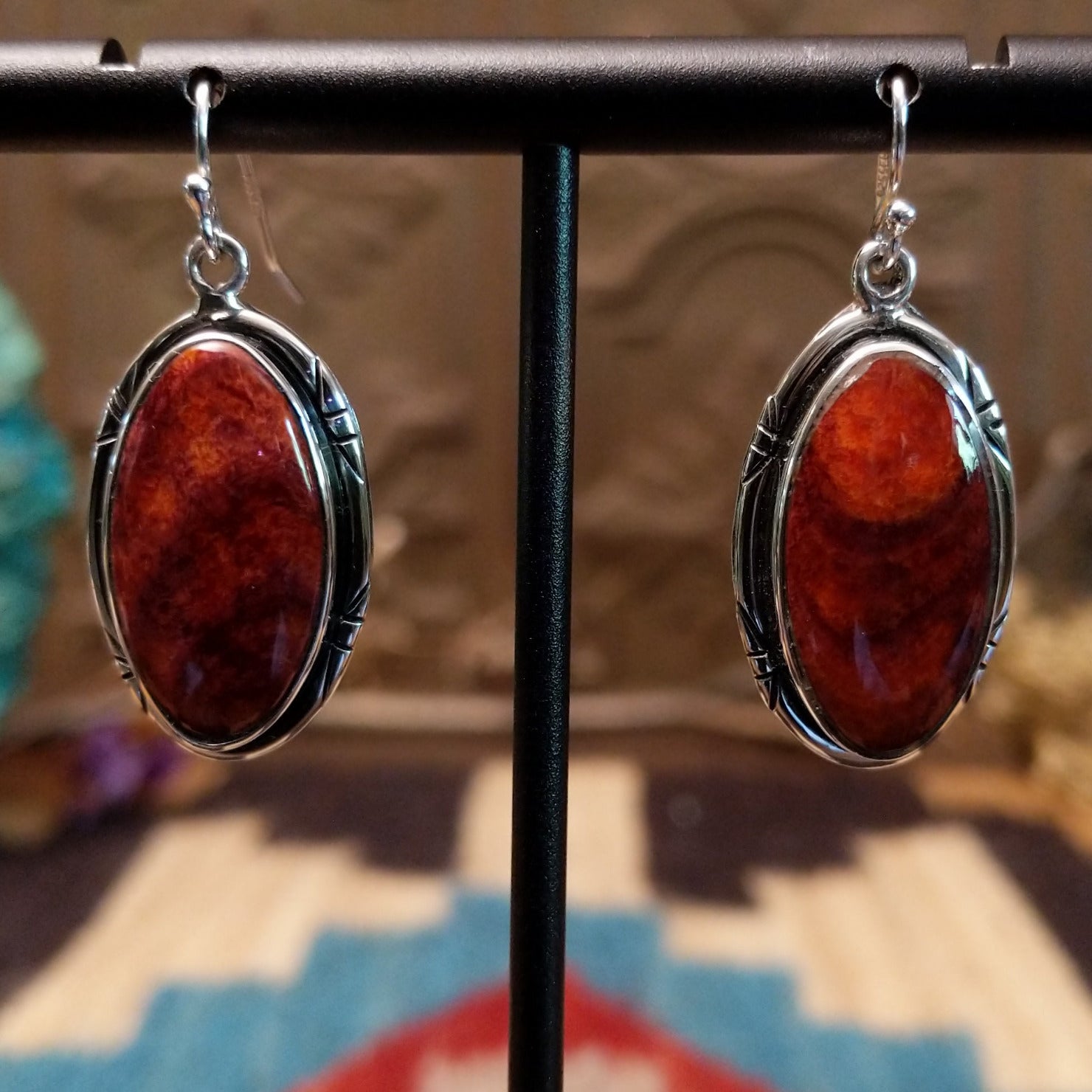 Sterling silver earrings with spiny oyster shell set in oval bezels, framed by incised settings.
