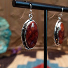 Sterling silver earrings with spiny oyster shell set in oval bezels, framed by incised settings.