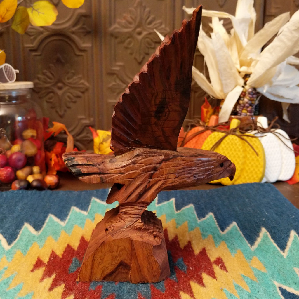 Ironwood carved into a detailed eagle taking flight.