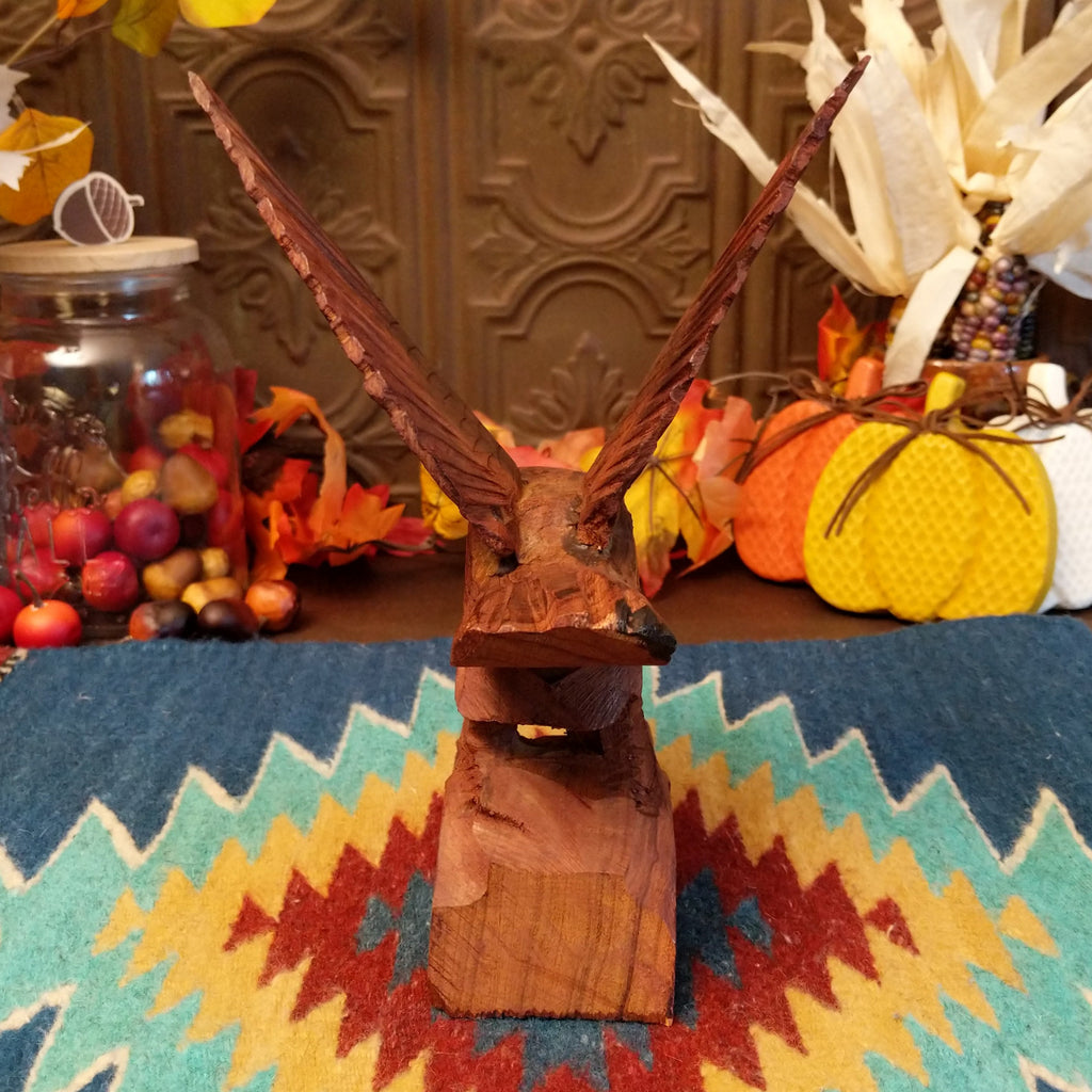 Ironwood carved into a detailed eagle taking flight.