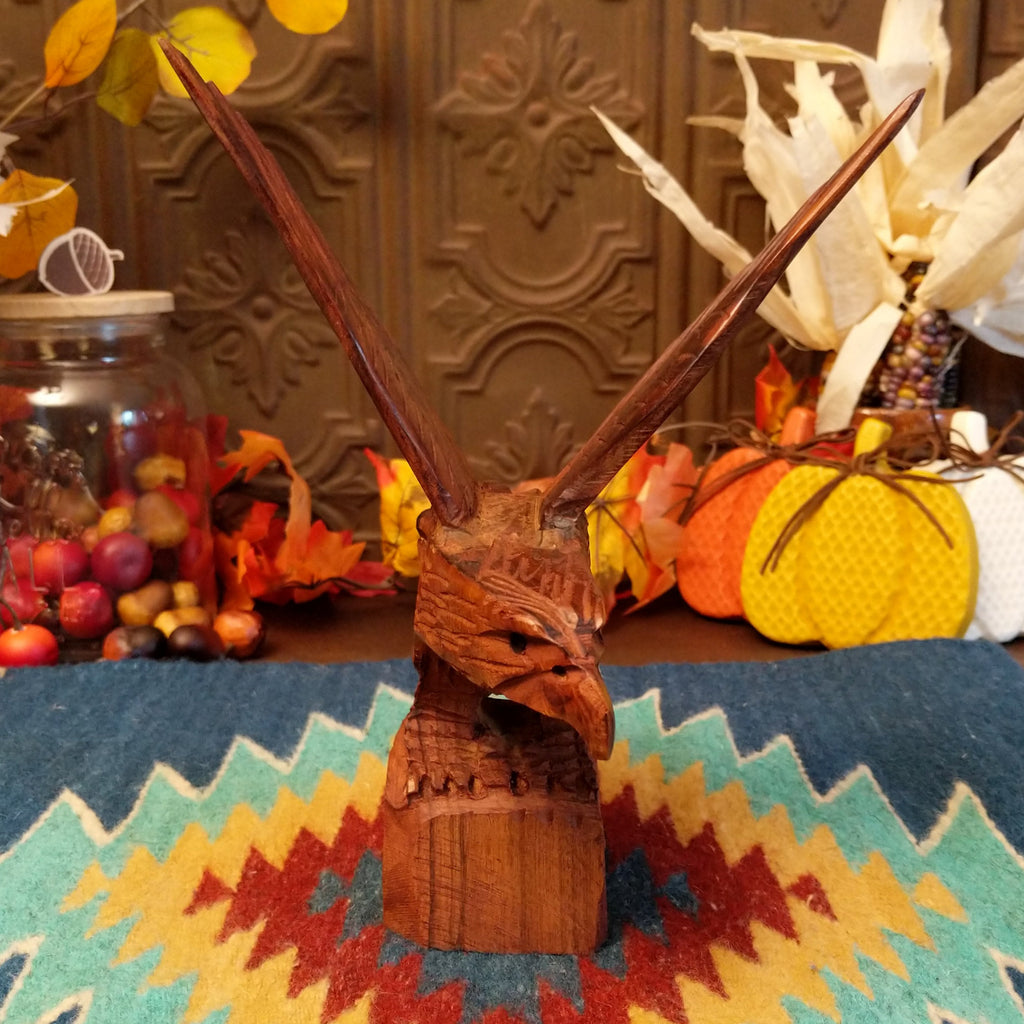Ironwood carved into a detailed eagle taking flight.
