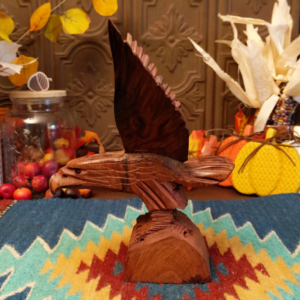 Ironwood carved into a detailed eagle taking flight.