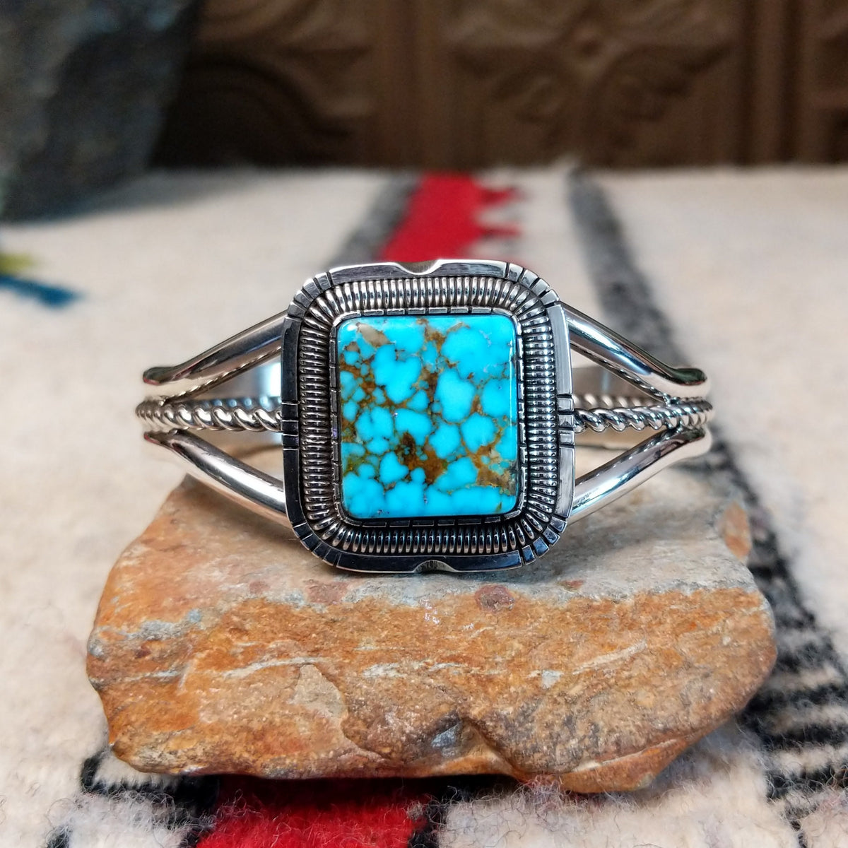 Silver cuff by Walter Vandever featuring a large square Kingman turquoise stone with brown matrix, framed by detailed silverwork and a split-band design with a twisted center strand.