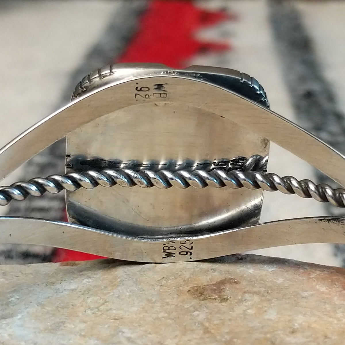 Silver cuff by Walter Vandever featuring a large square Kingman turquoise stone with brown matrix, framed by detailed silverwork and a split-band design with a twisted center strand; artisan and Sterling Silver stamp.