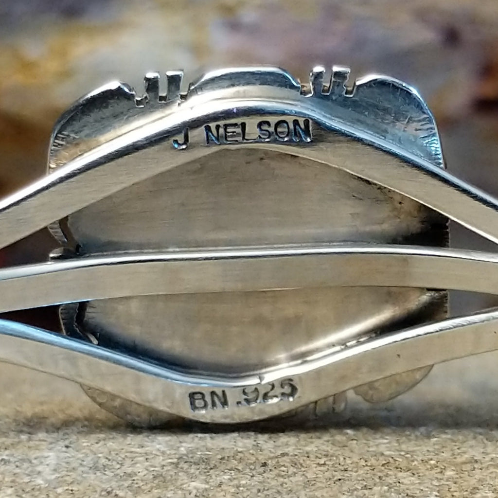 The artist's signature is stamped into the inside of the band.