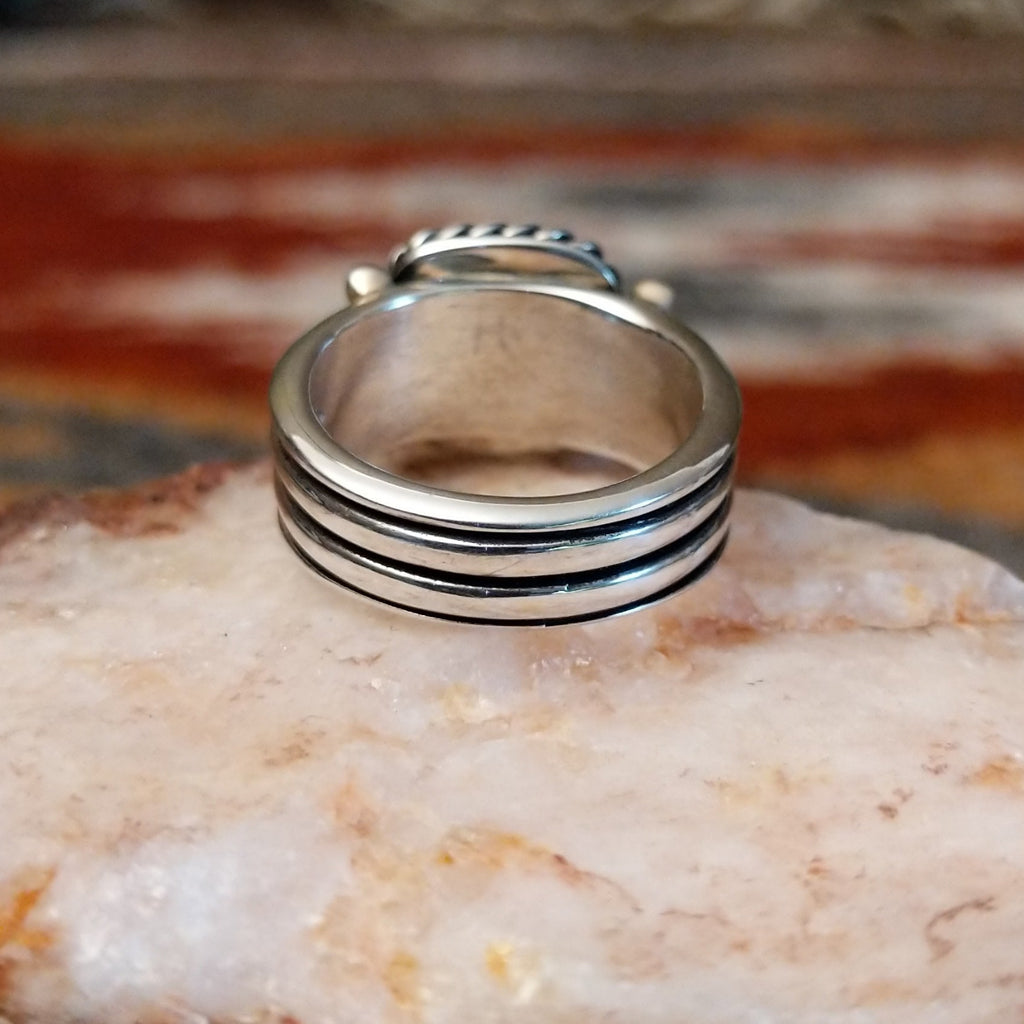 Square rhodochrosite framed by the twisted rope, with a dotted and layered band of the ring.