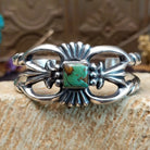 Sterling silver cuff with Royston turquoise set in a square bezel and ornate silverwork band.