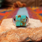 Square Turquoise Inlay Ring by Wilbert Grey featuring geometric turquoise inlay with natural brown matrix, separated by Sterling Silver channels and set on a polished silver band.