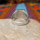 Square Turquoise Inlay Ring by Wilbert Grey featuring geometric turquoise inlay with natural brown matrix, separated by Sterling Silver channels and set on a polished silver band; underside view.