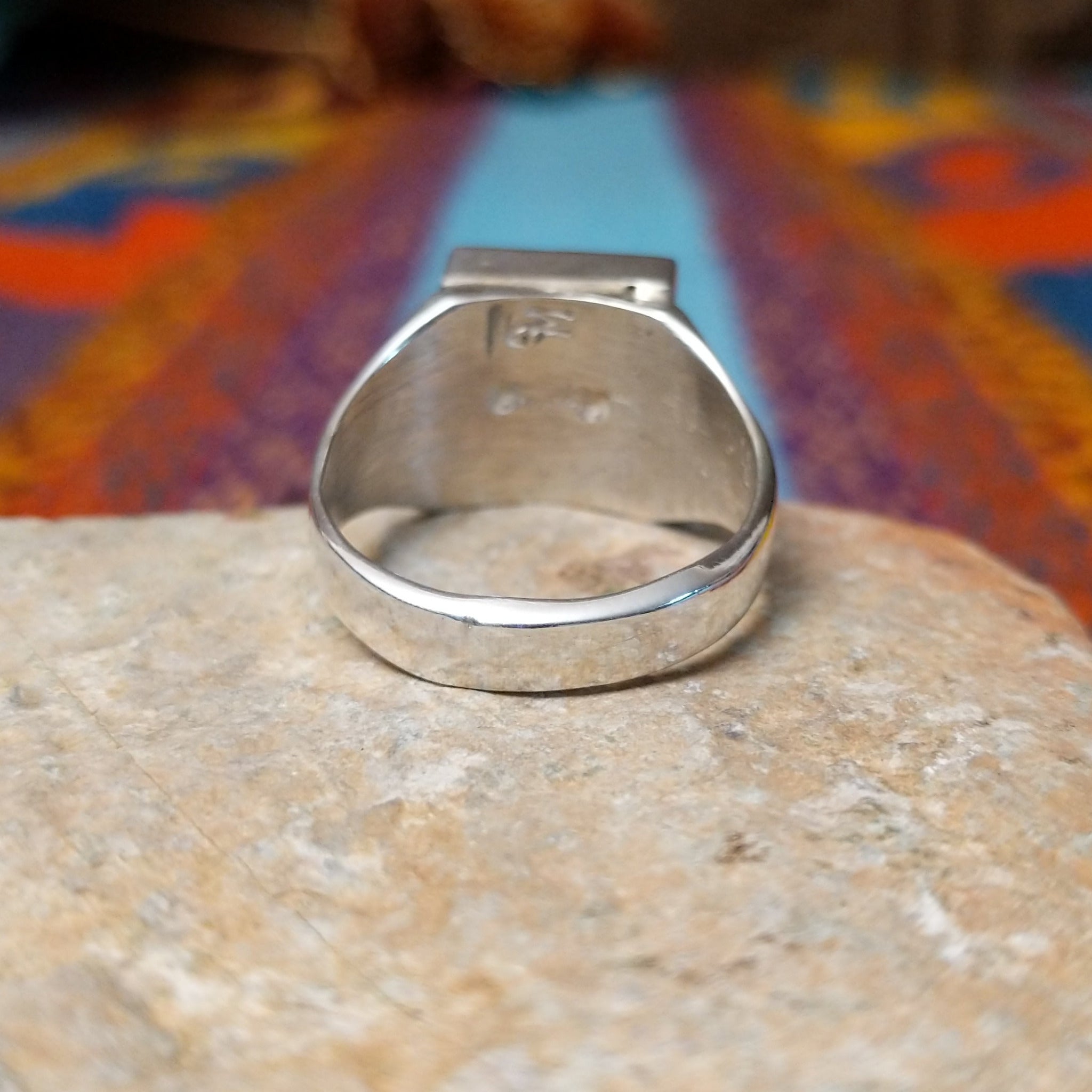 Square Turquoise Inlay Ring by Wilbert Grey featuring geometric turquoise inlay with natural brown matrix, separated by Sterling Silver channels and set on a polished silver band; underside view.
