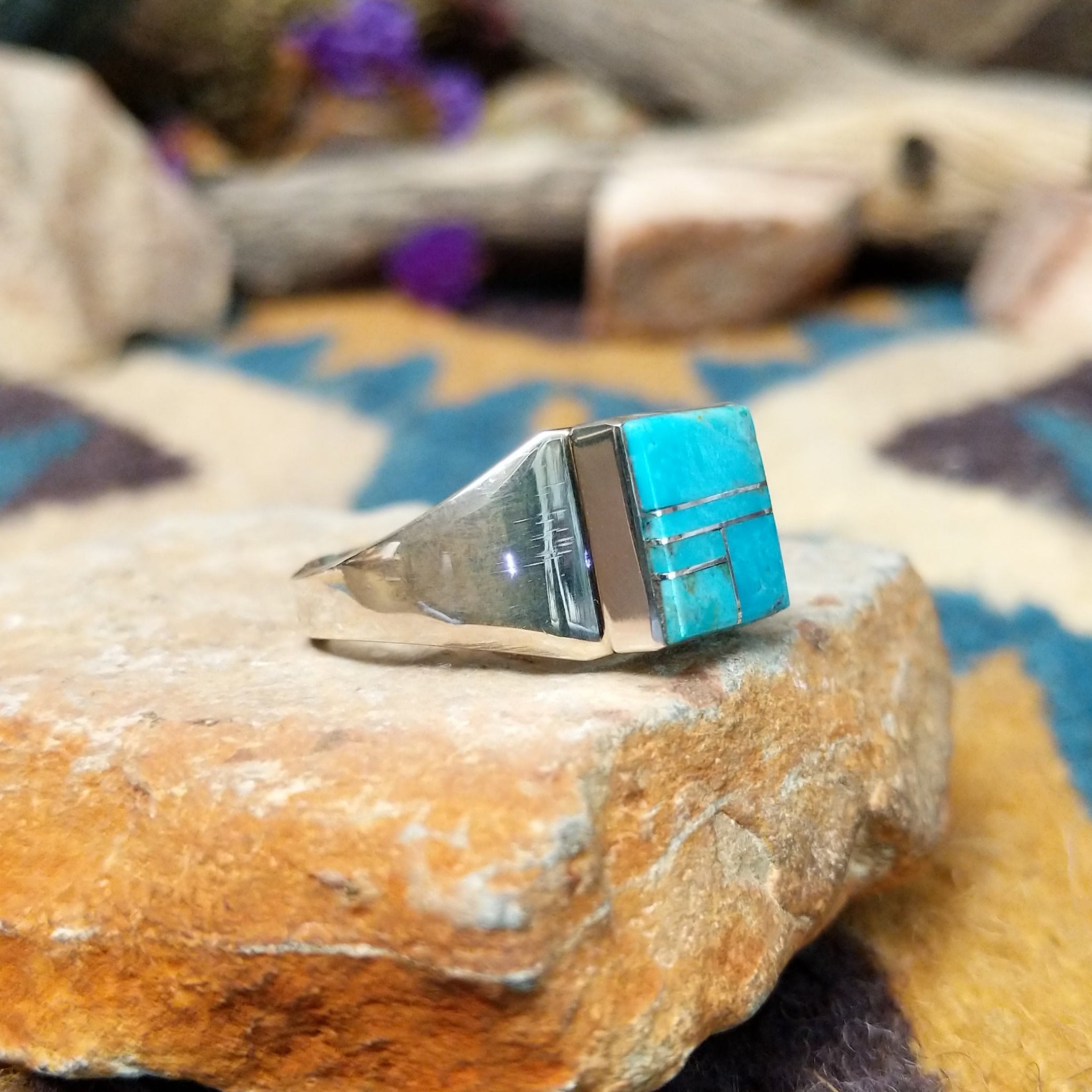 Sterling silver square Turquoise inlay ring by Wilbert Grey with geometric silver accents; side view.