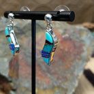 Handcrafted sterling silver inlay earrings by O. James, featuring a curved design with colorful multistone inlay; side view.
