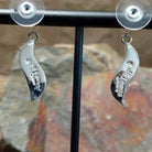 Handcrafted sterling silver inlay earrings by O. James, featuring a curved design with colorful multistone inlay; artisan and Sterling Silver stamp.