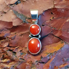 Sterling silver pendant with coral set in the two bezels.