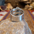 Stacked sterling silver ring with coral set in three oval bezels and stamping on the bands.