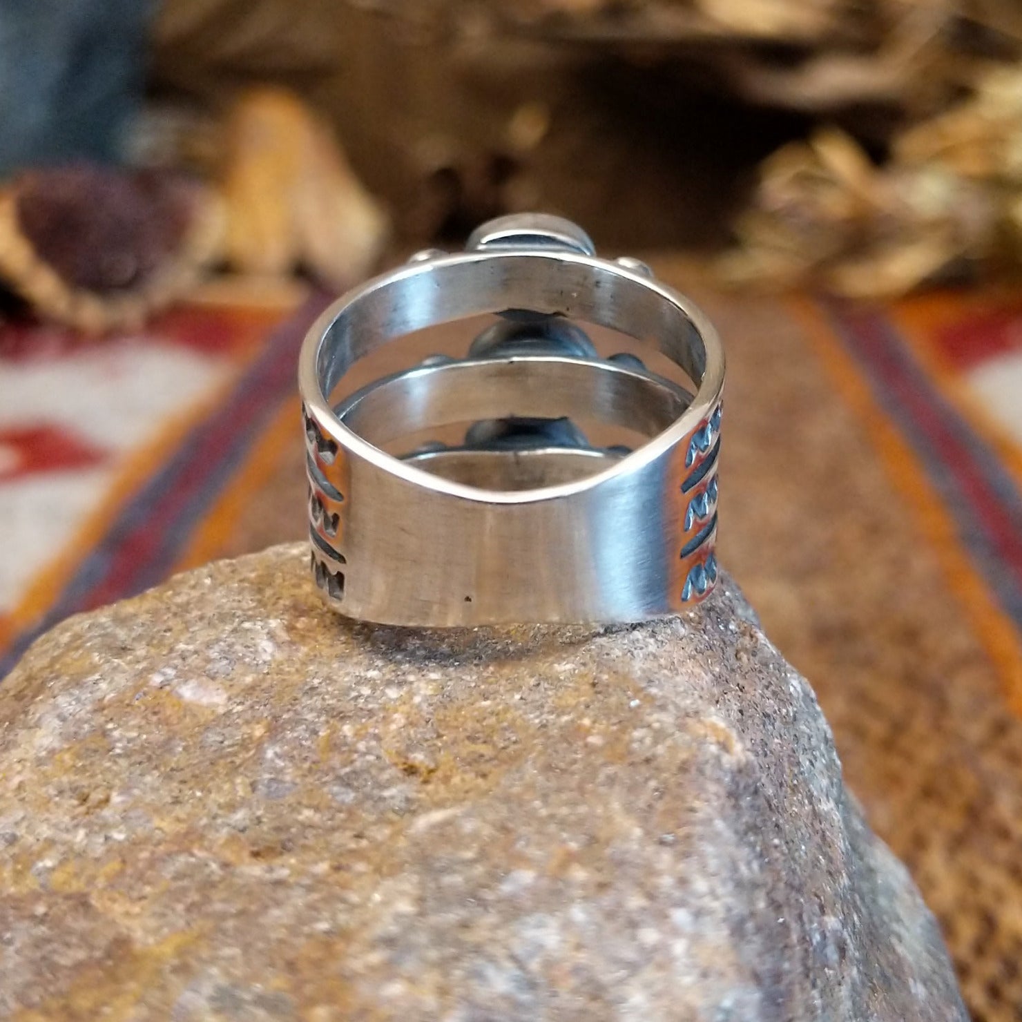 Stacked sterling silver ring with coral set in three oval bezels and stamping on the bands.
