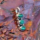 Stacked pendant with malachite set within the bezels.
