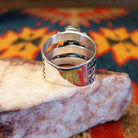 Stacked sterling silver ring with manmade opal set in oval bezels, featuring stamped patterns on the band.