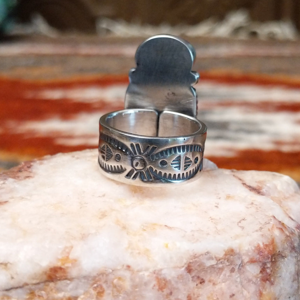 The band of the ring features ornate details.