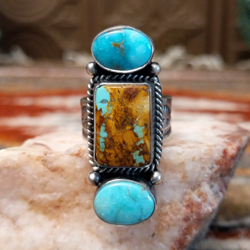 Stacked sterling silver ring of sonoran gold turquoise and boulder turquoise featuring twisted rope and dotted accents.