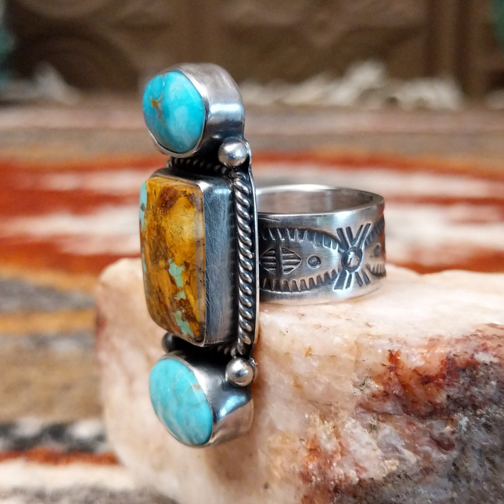 Stacked sterling silver ring of sonoran gold turquoise and boulder turquoise featuring twisted rope and dotted accents.