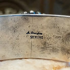 Close-up of the artisan's stamped signature.