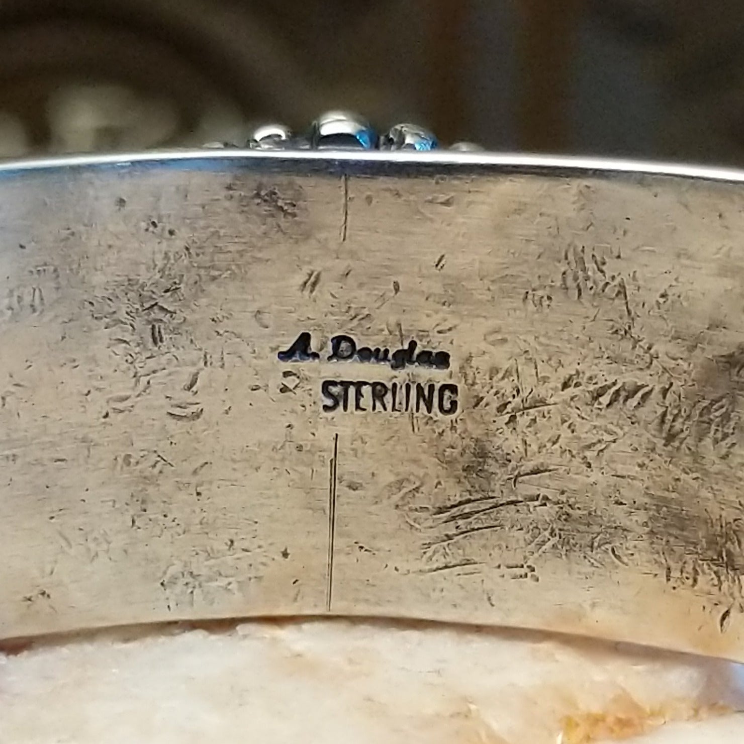 Close-up of the artisan's stamped signature.