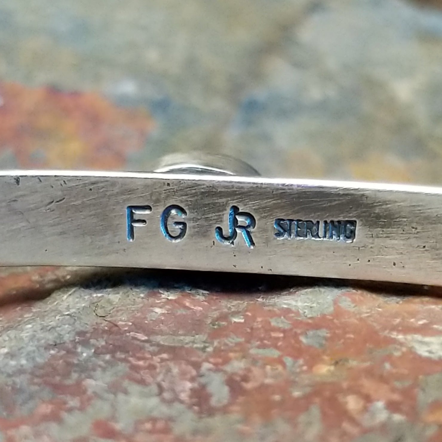 Close-up of the artisan's stamped signature.