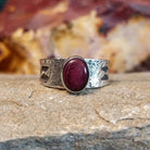 Purple spiny oyster shell set in a smooth bezel on a textured and stamped base.