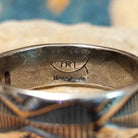 Handcrafted Navajo sterling silver stamped ring by Travis Teller featuring a wide band with deep traditional geometric stampwork and an oxidized finish; artisan and Sterling Silver stamp.