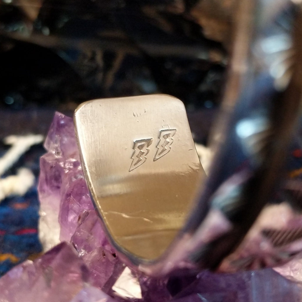 A detailed stamp on the tip of the cuff.