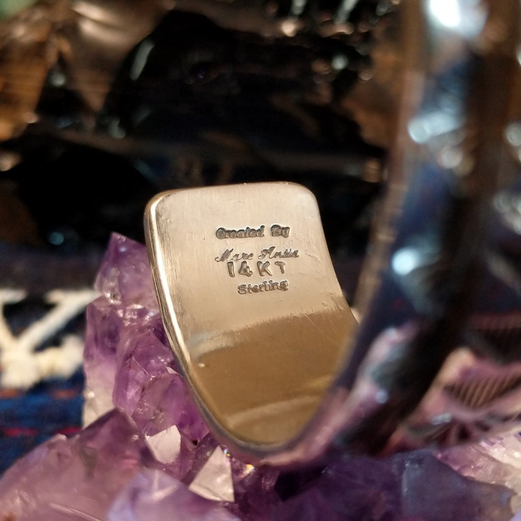 The tip of the cuff showcases the artist's signature and authentications on the band.