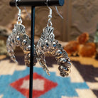 Sterling silver naja earrings with stamping and dotted accents.