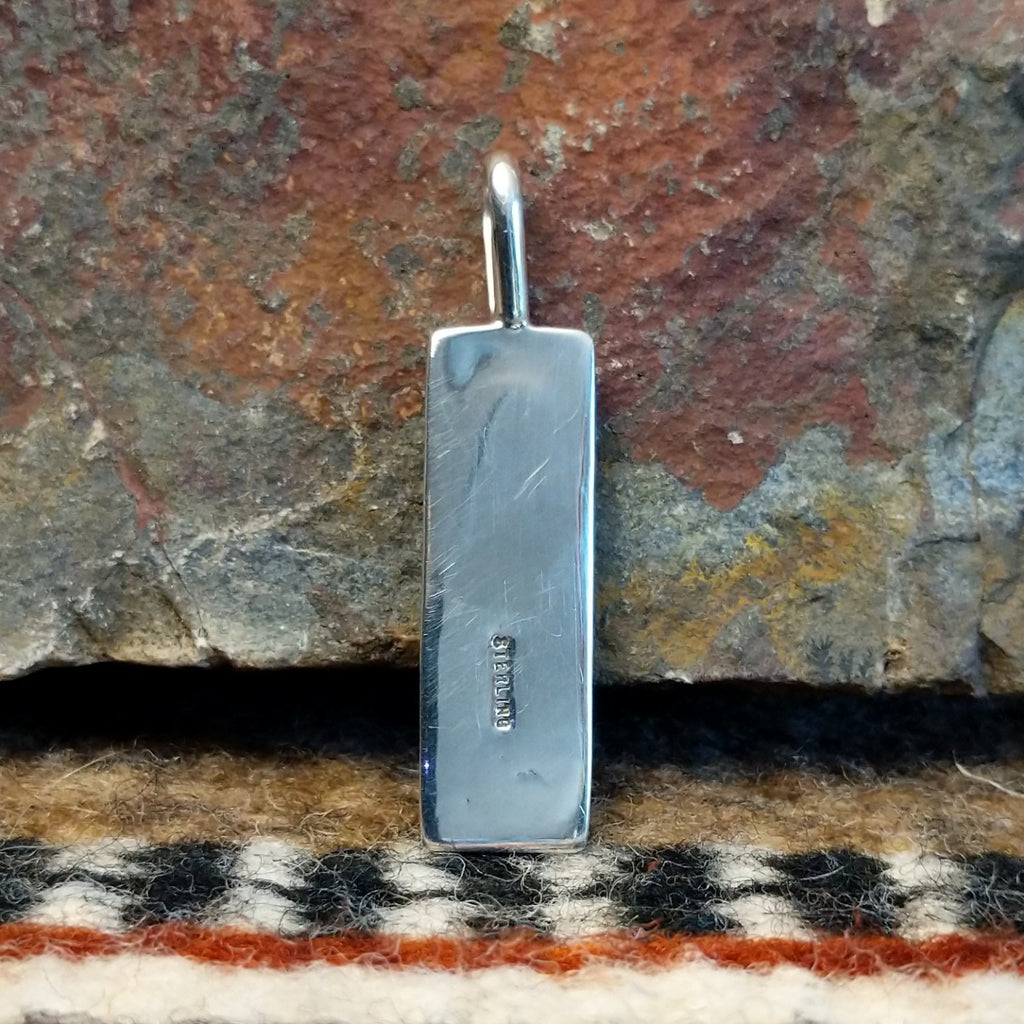 The back features the authentication stamp.