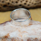 Stamped sterling silver ring by Raymond Coriz, featuring intricate hand-stamped patterns on a polished sterling silver band with traditional Southwestern-inspired craftsmanship.  Underside view.
