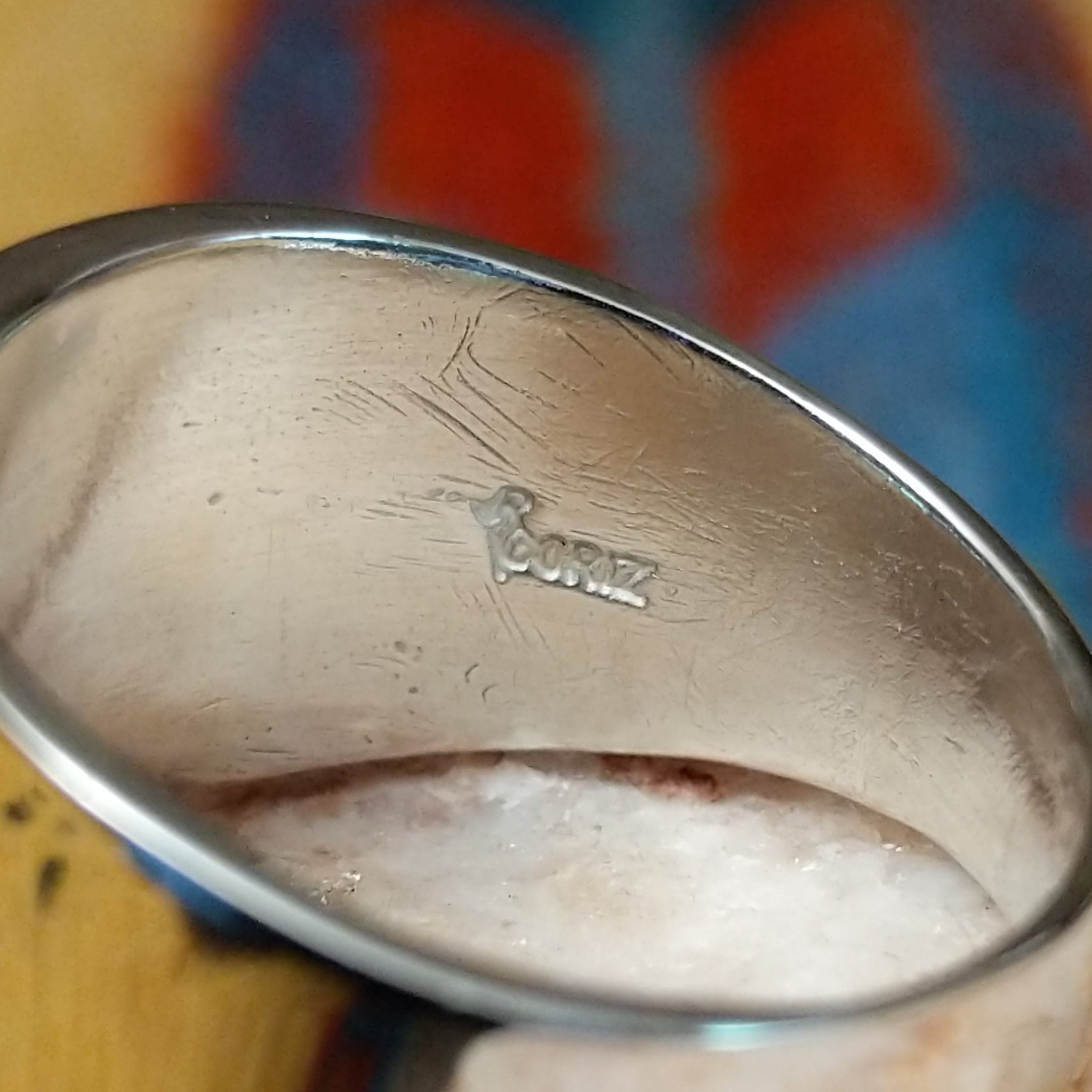 Stamped sterling silver ring by Raymond Coriz, featuring intricate hand-stamped patterns on a polished sterling silver band with traditional Southwestern-inspired craftsmanship.  Artisan stamp.