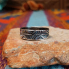 Stamped Silver Ring by Travis Teller with fan, chevron, and winding line details.