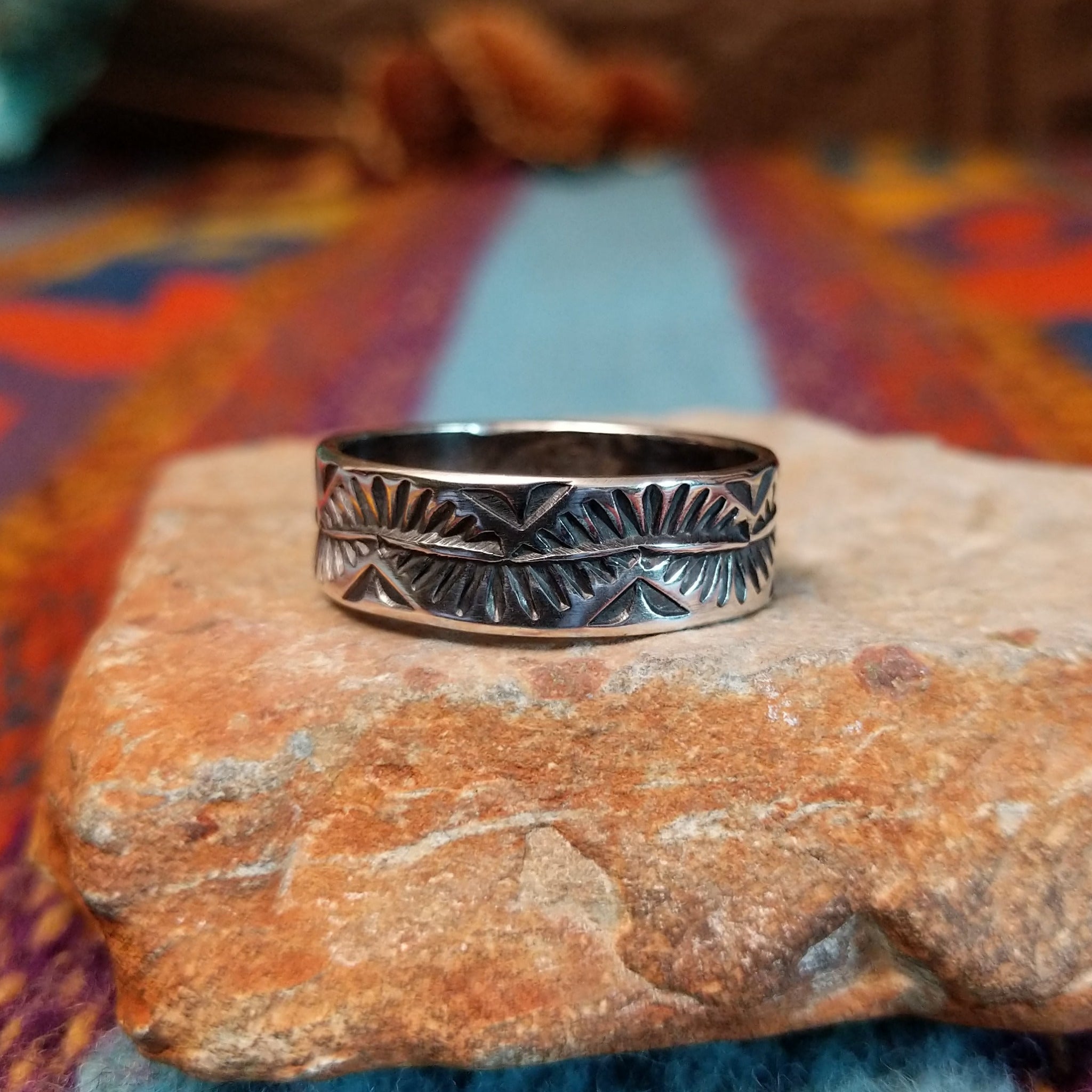 Stamped Silver Ring by Travis Teller with fan, chevron, and winding line details.