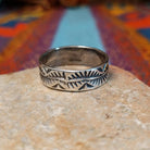 Stamped Silver Ring by Travis Teller with fan, chevron, and winding line details.