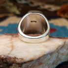 Sterling silver ring with wild horse stone set in the rectangular bezel and geometric stamping on the band.