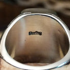 Close-up of the artisan's stamped signature.